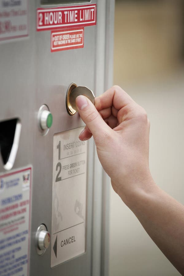 Inserting a Coin into the Parking Meter. Conceptual Image Shot Stock