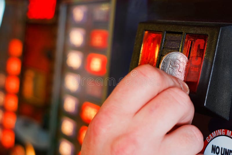 Inserting coins into Gaming machine royalty free stock images