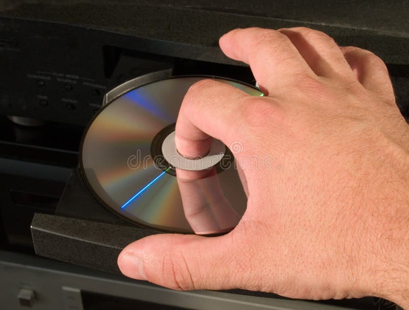 Arm inserting dvd blu-ray disk in the audio hi-fi player. Arm inserting dvd blu-ray disk in the audio hi-fi player