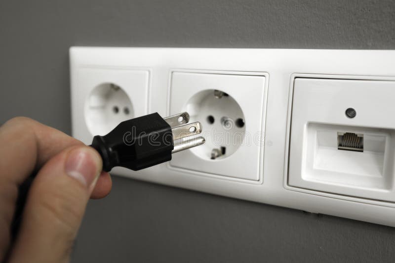 Inserting plug in outlet royalty free stock photos