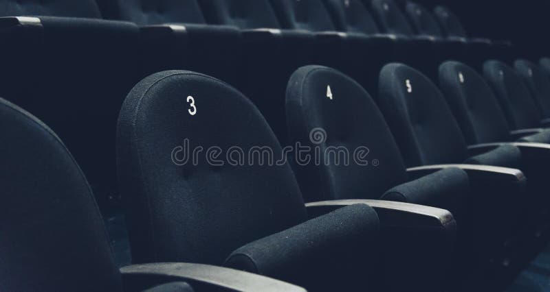 Inside of auditorium movie theatre with seats and numbers.