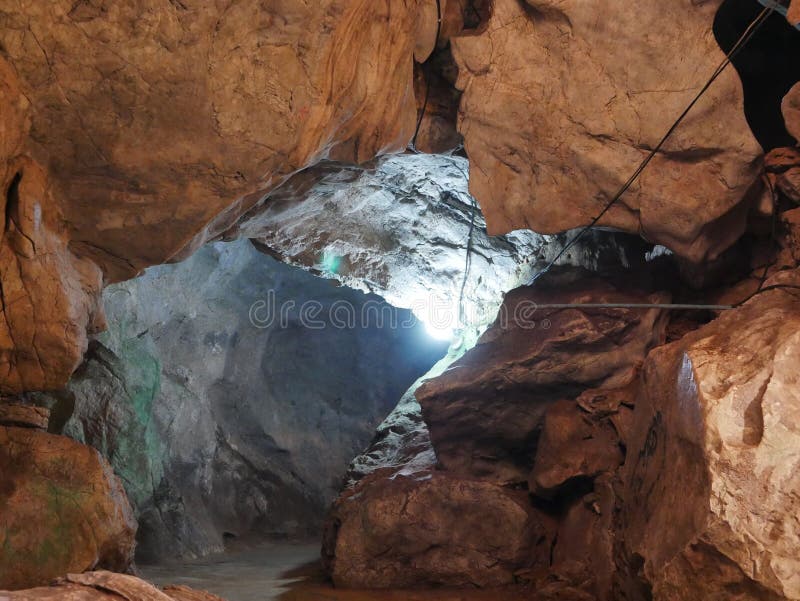 Inside of a deep cave with lighting system on to provide a visibility stock images