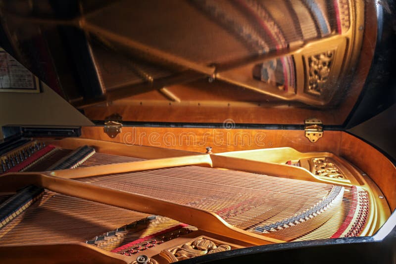 Inside a grand piano with mirroring of frames and strings in the open lid of the musical instrument, concept for music, art and entertainment, selected focus, narrow depth of field. Mirroring object stock images, royalty-free photos and pictures
