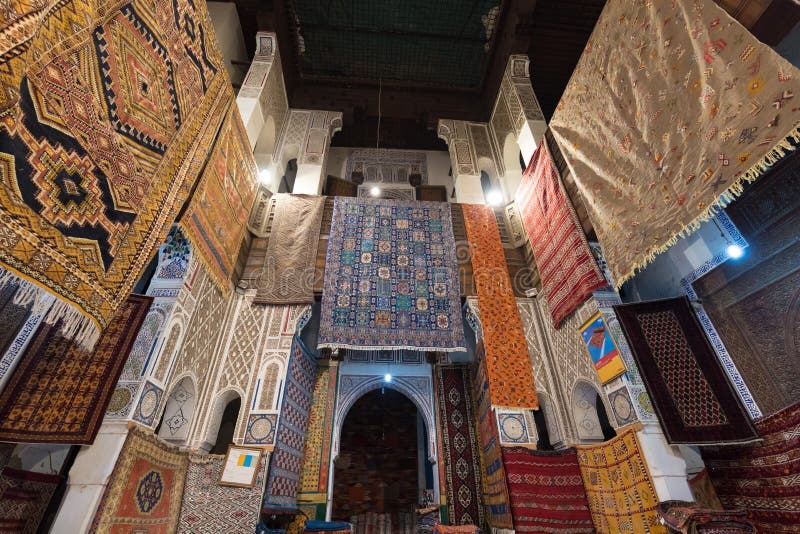 Inside interior of Carpet shop with colourful moroccan rugs and berber carpets on display in a souk market in the centre of medina