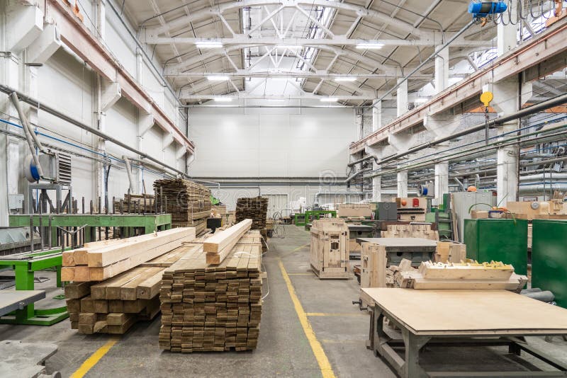Inside interior factory workshop with stacks of wood for making molds and carpentry machine tools stock image