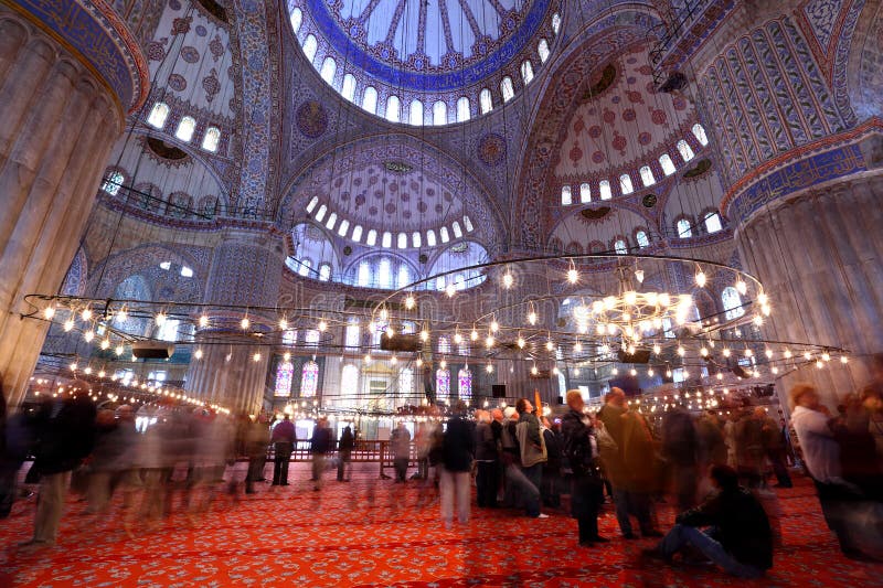 Long exposure showing the architecture and tourists inside the famous Blue Mosque in Istanbul.