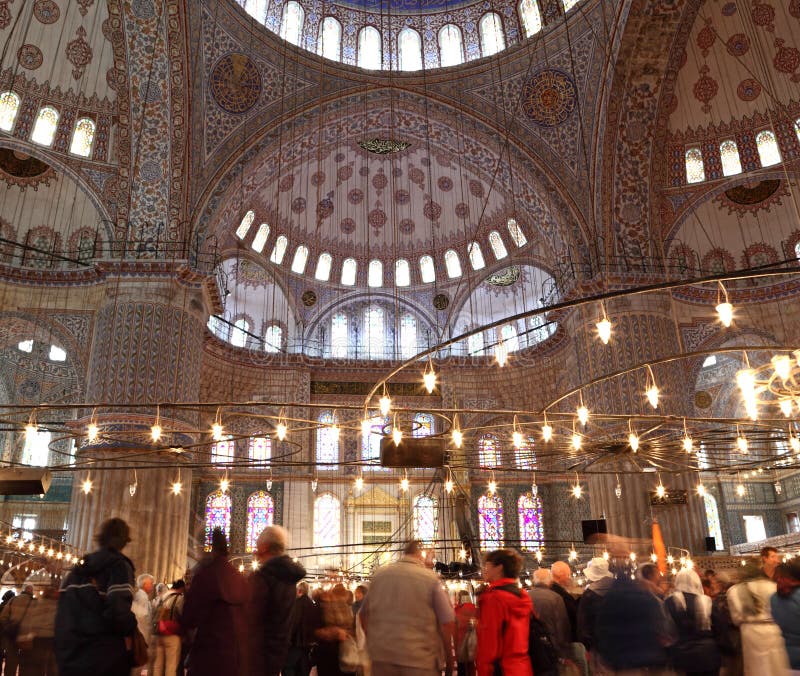 Long exposure showing the architecture and tourists inside the famous Blue Mosque in Istanbul.