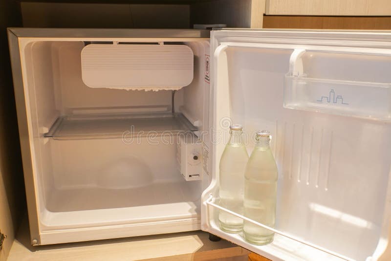 Inside the Mini Fridge in Hotel Bedroom with Water Bottle Stock Image
