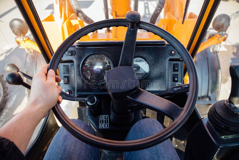 Inside modern tractor. Steering wheel. View from work place royalty free stock photo