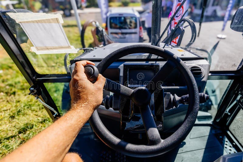 Inside modern tractor. Steering wheel. View from work place royalty free stock photos