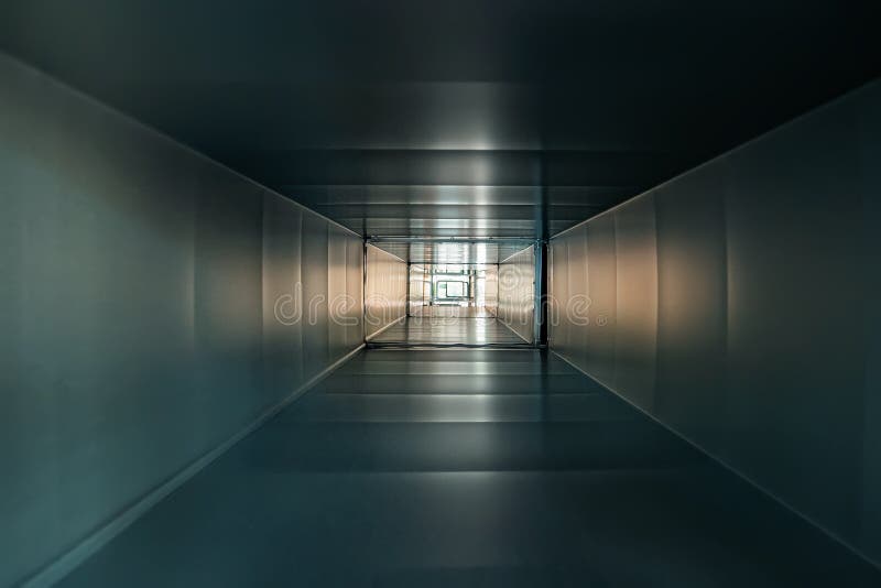 Inside square iron or metal pipe or tube as abstract industrial background, corridor or tunnel view with light stock images Inside square iron or metal pipe or tube as abstract industrial background, corridor or tunnel view with light stock images
