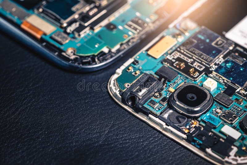 The inside of the twin smartphone`s motherboard lay on the back table and copy space royalty free stock images