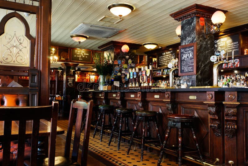 LONDON - April 26: Interior of pub, for drinking and socializing, focal point of the community, on April 26, 2017, London, UK. Pub business, now about 53,500 pubs in UK, has been declining every year. LONDON - April 26: Interior of pub, for drinking and socializing, focal point of the community, on April 26, 2017, London, UK. Pub business, now about 53,500 pubs in UK, has been declining every year