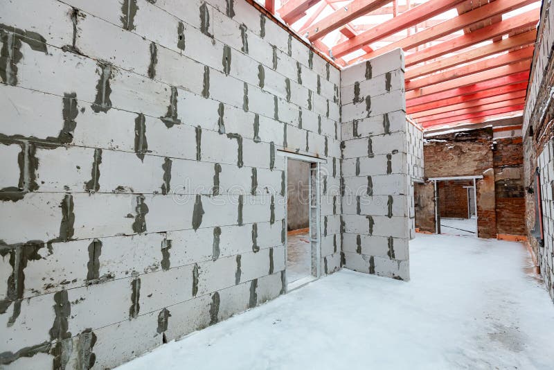 Inside view of working process of building house with wall made from foamed concrete block and metal platform. Concept royalty free stock photography