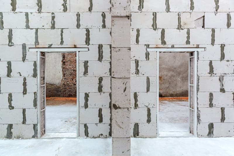 Inside view of working process of building house with wall made from foamed concrete blocks. Concept of construction stock image