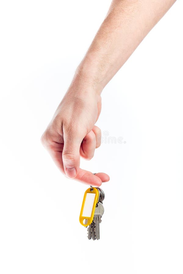 Insieme della tenuta della mano delle chiavi con il nametag giallo fotografia stock Insieme della tenuta della mano delle chiavi con il nametag giallo fotografia stock