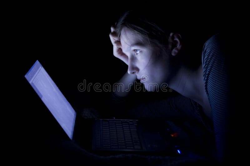 Insomnia. Young woman with laptop at night Insomnia. Young woman with laptop at night