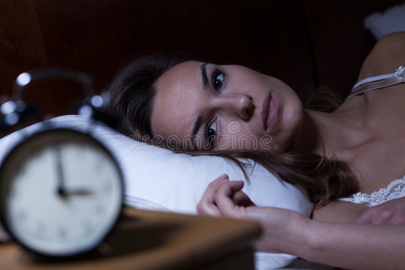 Frau im Bett liegend, der an Schlaflosigkeit leidet.