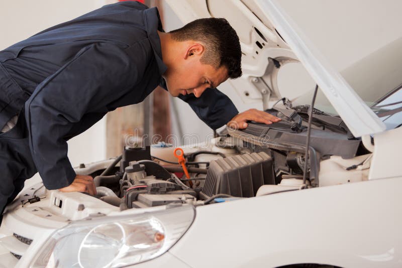 Inspecting a car engine royalty free stock images Inspecting a car engine royalty free stock images