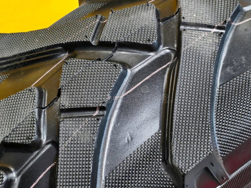 Detailed view of construction equipment wheels highlighting tread patterns and surface wear in a workshop environment, emphasizing durability and functionality. Load structural stock images, royalty-free photos and pictures