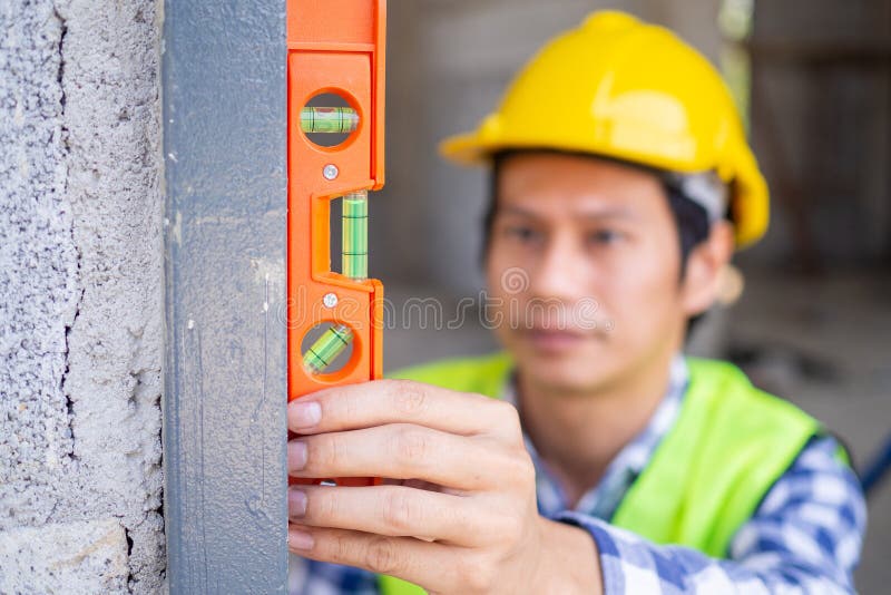 The inspectors are measuring the door frame level. To meet the standards real estate inspections or home inspections before delivering a home to customers.