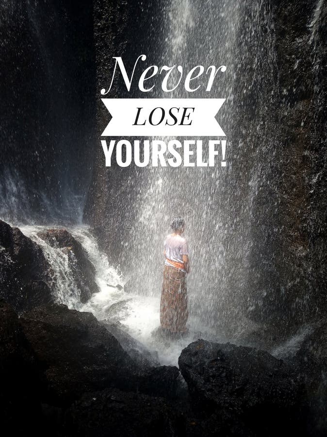 Inspirational motivational quote-Never lose yourself. a young woman stands alone under splashes of waterfall, relieving the