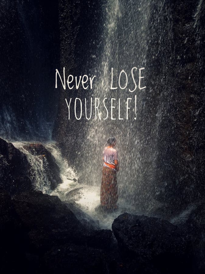 Inspirational motivational quote-Never lose yourself. a young woman stands alone under splashes of waterfall, relieving the