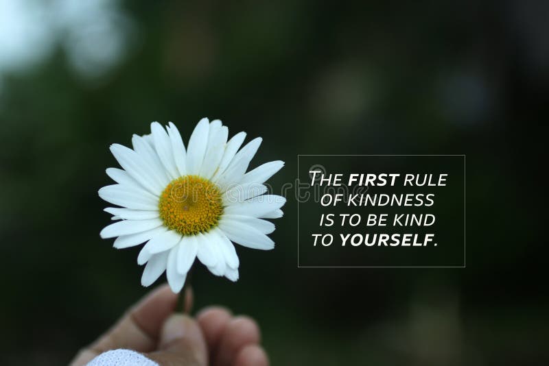 Inspirational quote - The first rule of kindness is to be kind to yourself. Self love care, healing concept with flower in hand.