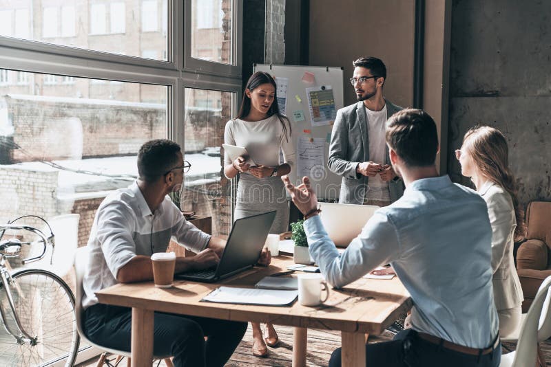 Inspired to work hard. Two young colleagues conducting a business presentation while working in the creative office royalty free stock images Inspired to work hard. Two young colleagues conducting a business presentation while working in the creative office royalty free stock images