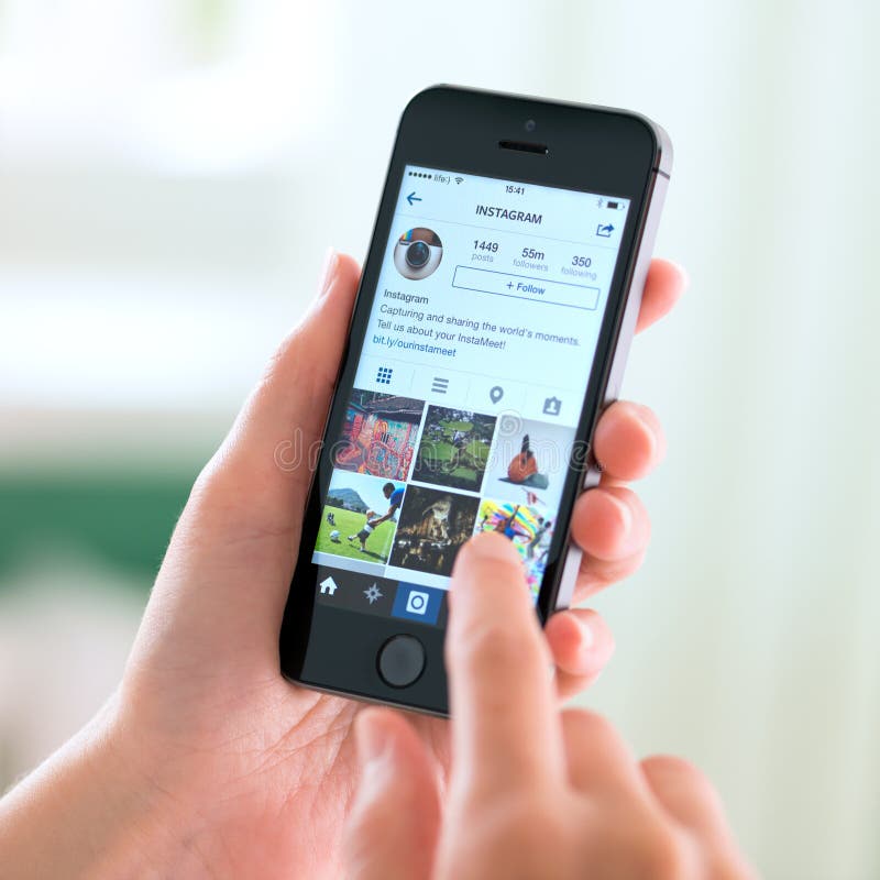 KIEV, UKRAINE - MAY 30, 2014: Person holding a brand new Apple iPhone 5S with Instagram profile on the screen. Instagram is an online mobile social networking service, launched in October 2010. KIEV, UKRAINE - MAY 30, 2014: Person holding a brand new Apple iPhone 5S with Instagram profile on the screen. Instagram is an online mobile social networking service, launched in October 2010.