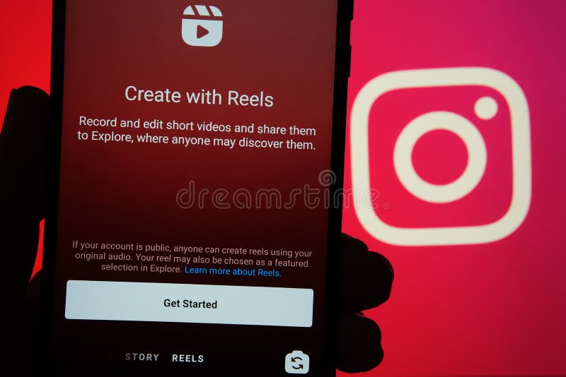 Instagram Reels start screen seen on mobile phone and Instagram logo on blurred background. New feature from Facebook aimed to cre