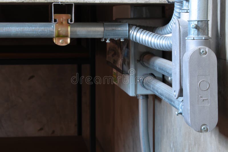 Electrical wiring work in a steel pipe of a house with a loft style decoration design. Electrical wiring work in a steel pipe of a house with a loft style decoration design