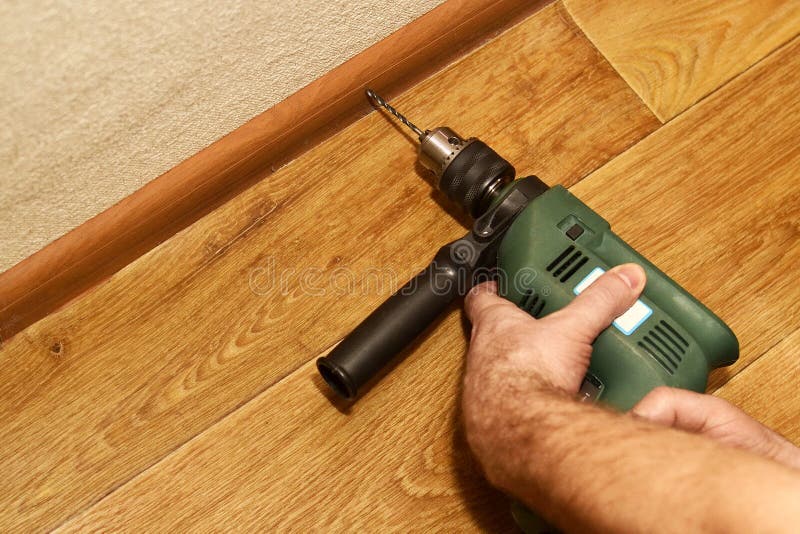 Installation Drilling Skirting Boards with a Drill Stock Image Image