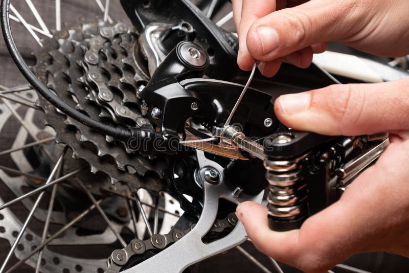 Installation of a Cable for Gear Shifting on a Bicycle Stock Image