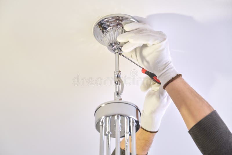 Installation Ceiling Lamp, Hands Of Electrician Fixing Chandelier Stock