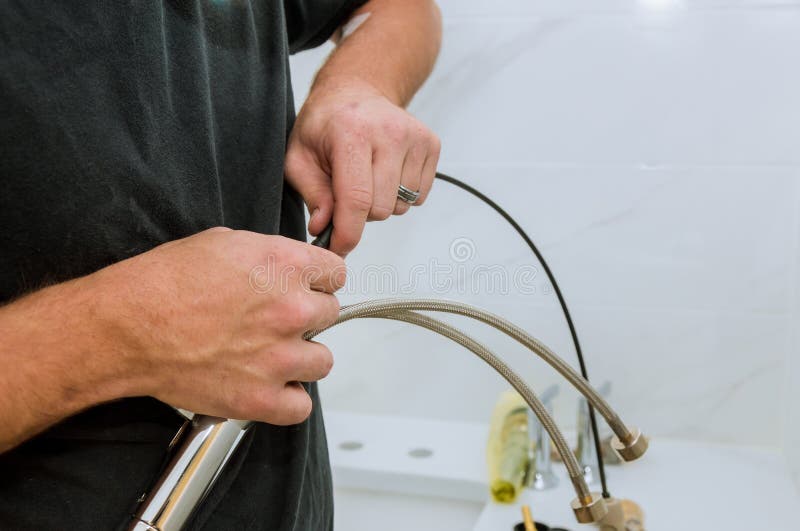 Installation of Chrome Faucet Plumber at Work in a Bathroom Stock Image