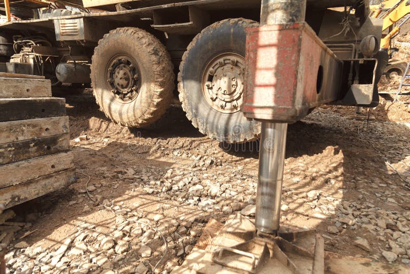 Installation of the crane on the ground for lifting of building materials. stock photos Installation of the crane on the ground for lifting of building materials. stock photos