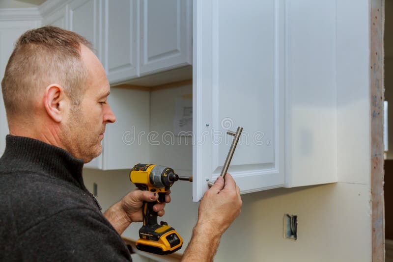 Installation of Door Handles on Kitchen with a Screwdriver