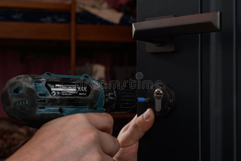 Installation of a Door Lock, a Carpenter Installs a Door Lock in a Door