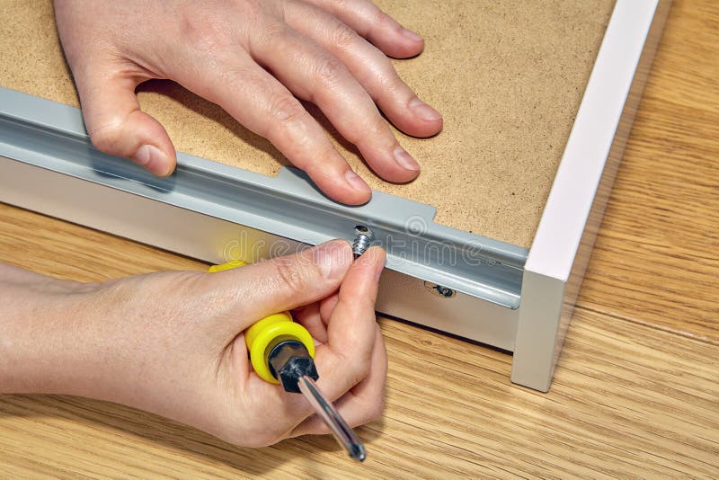 Installation of the Drawer by Means of Furniture Hardware. Stock Image