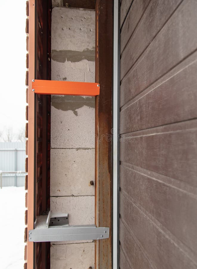 Installation of the gate in the garage metal stock images