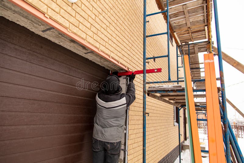 Installation of the gate in the garage metal royalty free stock image