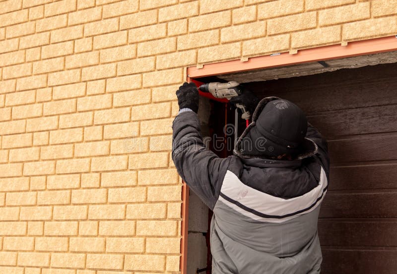 Installation of the gate in the garage metal stock photography