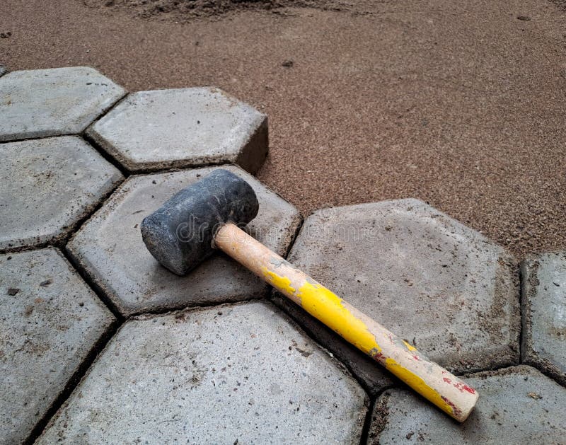 Installation of hexagon paving. Construction tools and details stock photo