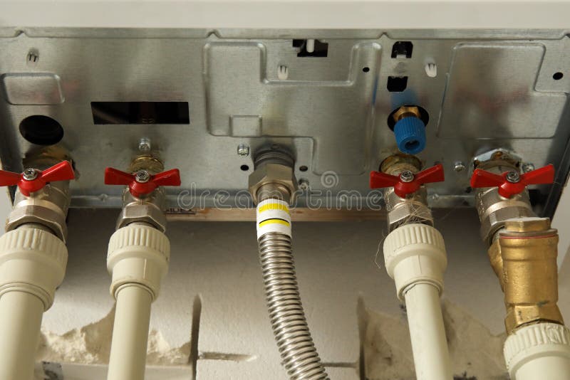 Installation of home gas heating boiler with red taps royalty free stock photos Installation of home gas heating boiler with red taps royalty free stock photos