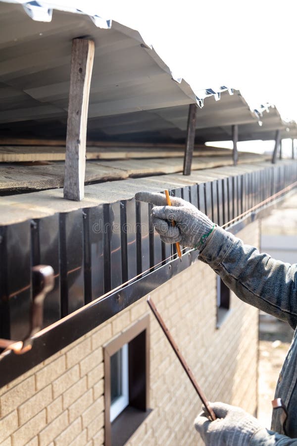 Installation of Metal Drain on the Roof of the House Stock Photo
