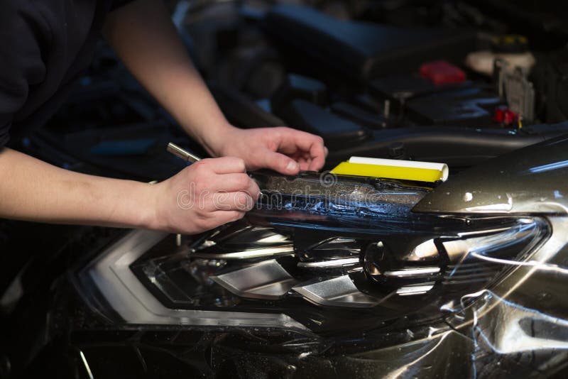 Installation of a Protective Film on the Headlights of the Car.Car Body