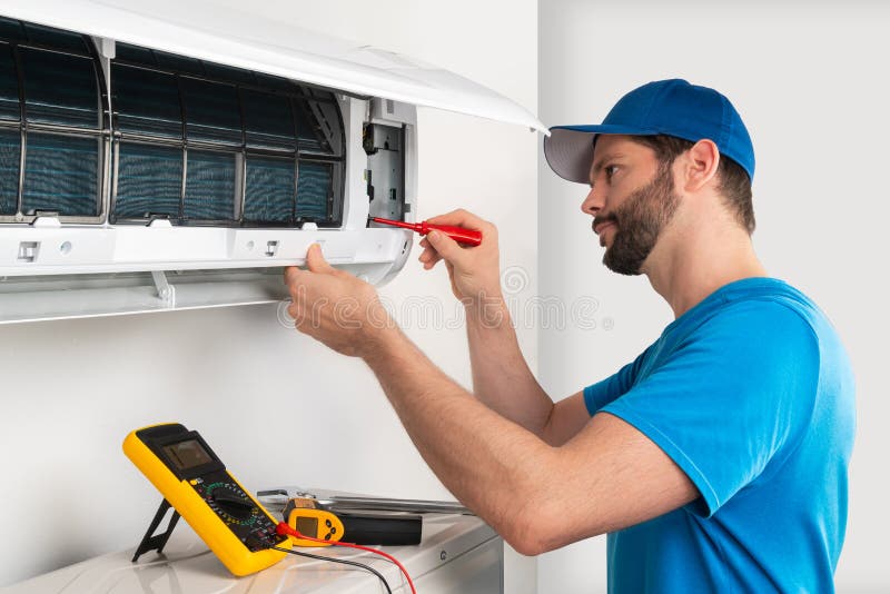 Installation service fix repair maintenance of an air conditioner indoor unit by cryogenist technican worker with screwdriver stock photo Installation service fix repair maintenance of an air conditioner indoor unit by cryogenist technican worker with screwdriver stock photo