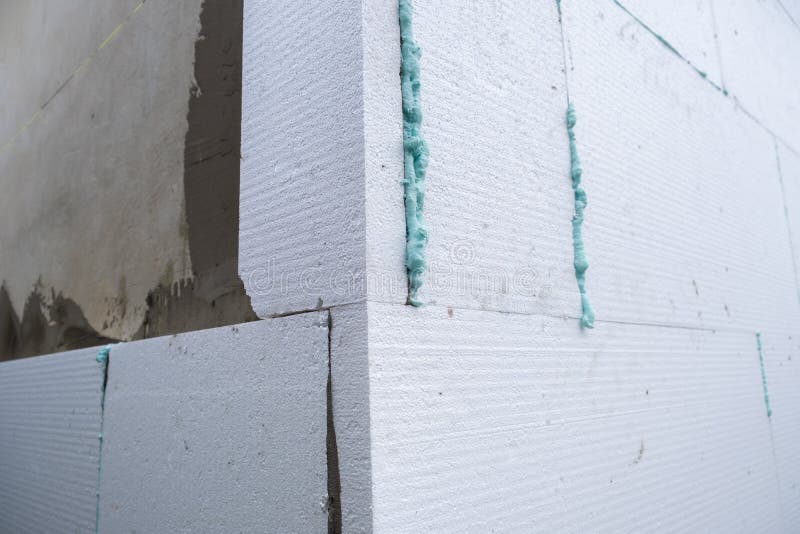 Installation of Styrofoam Insulation Sheets on House Facade Wall for