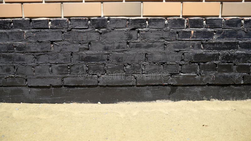 Installation of a waterproofing pit membrane to insulate the outer wall of a basement or foundation of a brick house stock image